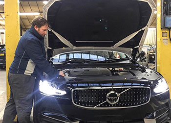 Temporary vehicle technician working on Volvo
