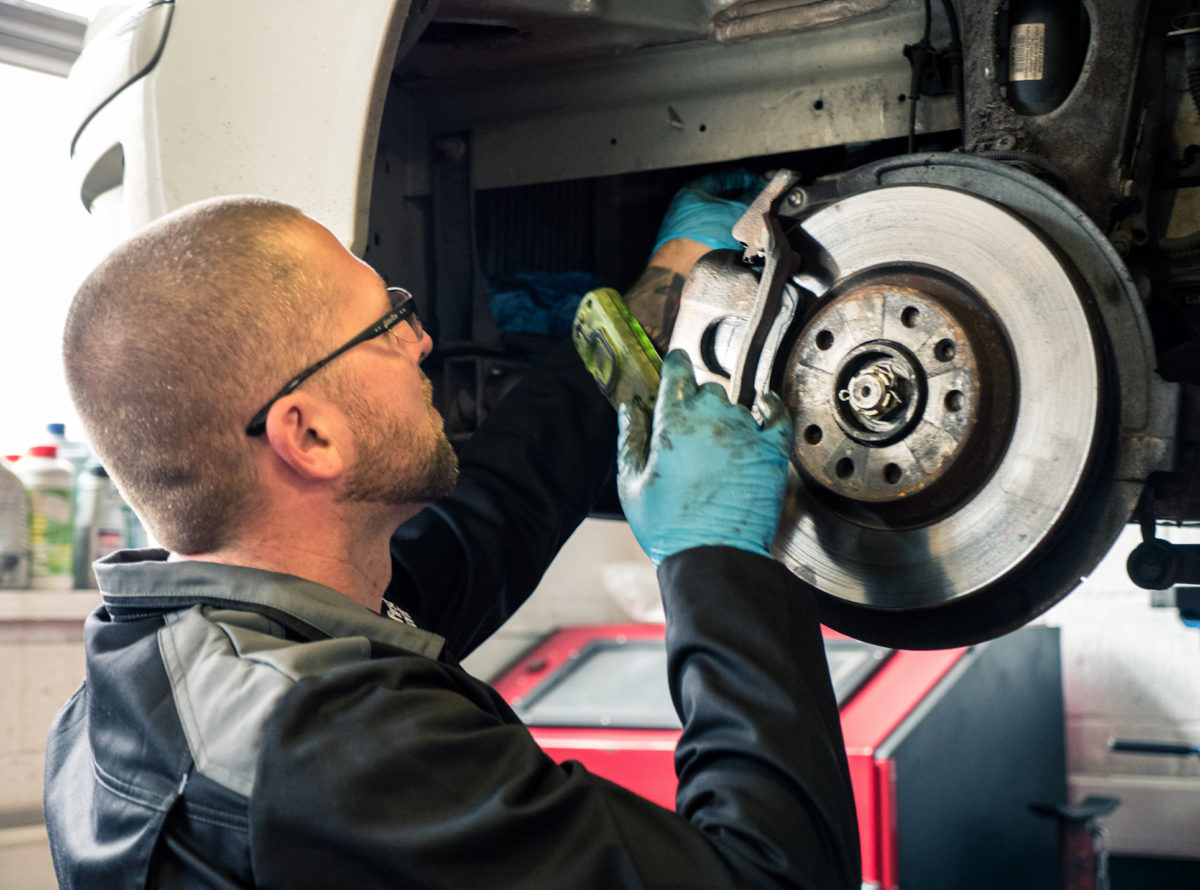 6 Recruiting Tips to Help Your Workshop Fill Vehicle Technician Vacancies Vehicle technician checking the wheel