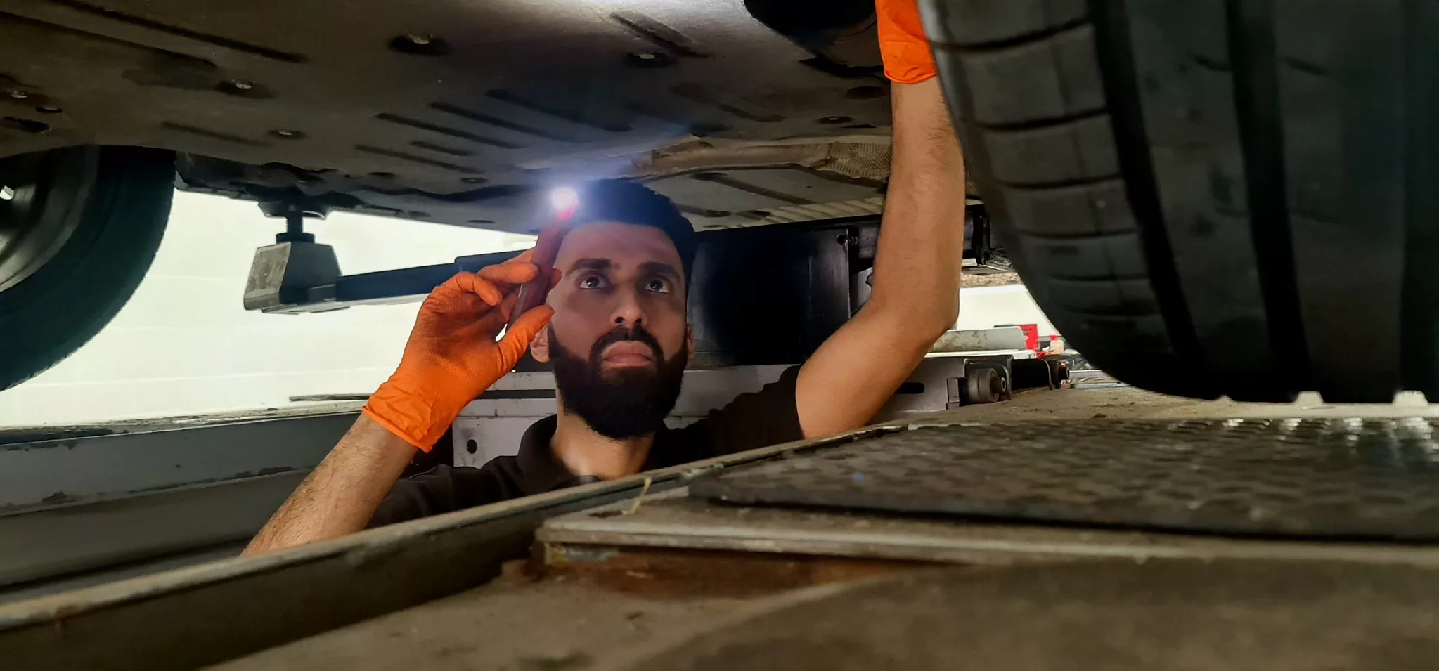 Usmaan working on a car
